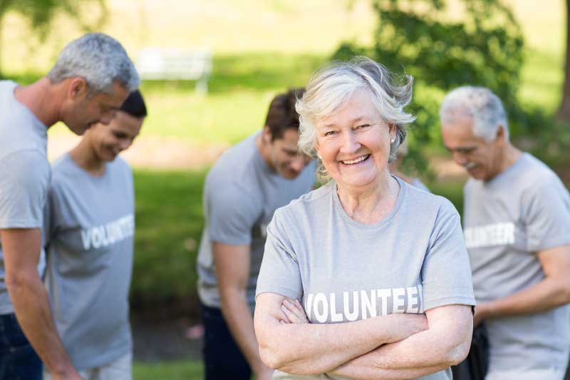 older lady in a volunteer shirt